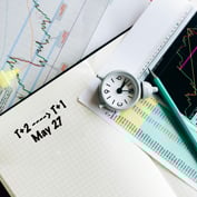 Image of book, clock, pencil and graph with words  representing change from T+2 to T+1 on May 27 2024 