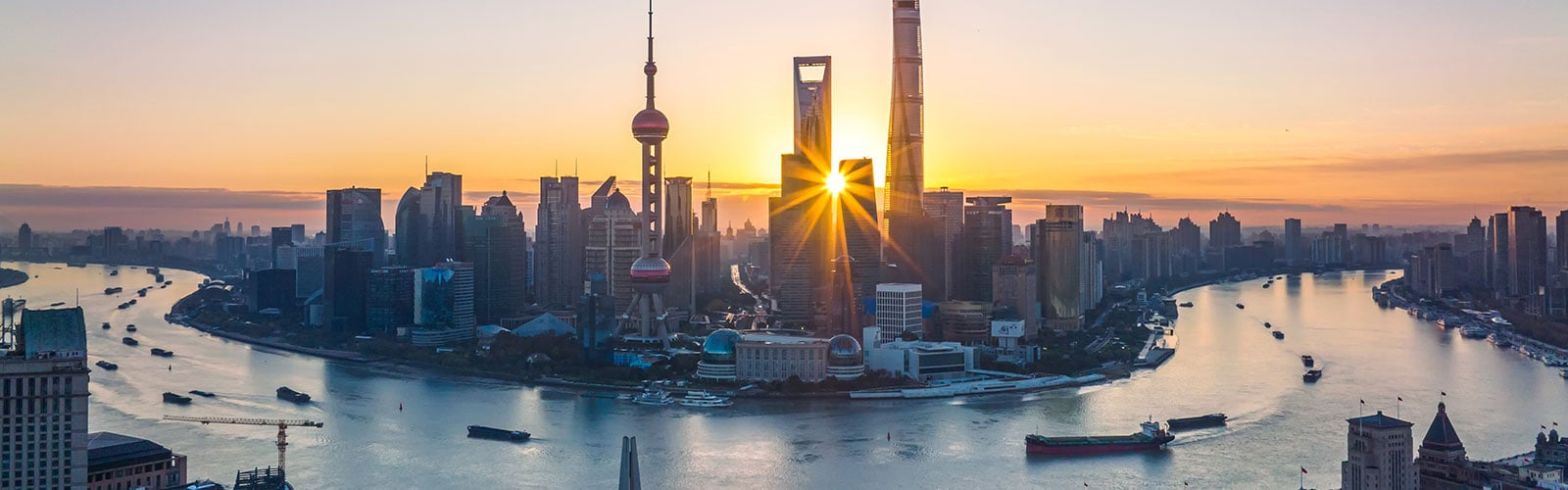 Sunrise over the Shanghai skyline, symbolizing growth in emerging markets.