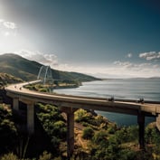 Bridge with motobike riders with mountains and ocean on either side